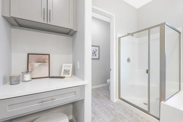 a bathroom with a shower sink and mirror