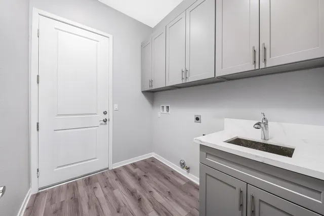 a kitchen with white cabinets and a sink