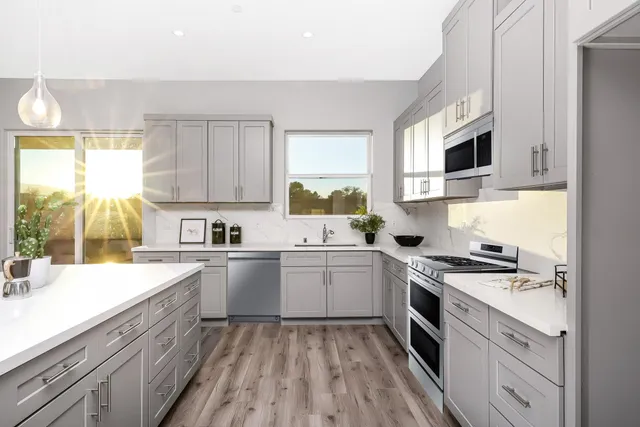 a kitchen with a sink stove and microwave