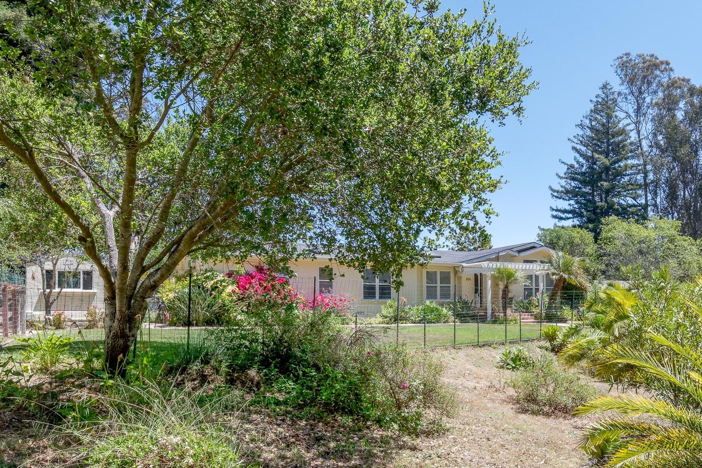 892-894 Calabasas Road Watsonville, CA 95076 - Photo 1 of 53 a front view of a house with a yard and potted plants