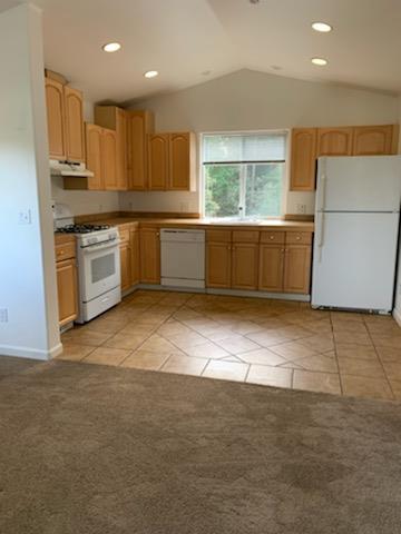892-894 Calabasas Road Watsonville, CA 95076 - Photo 40 of 53 a large kitchen with stainless steel appliances a large counter top a stove a sink a refrigerator and white cabinets