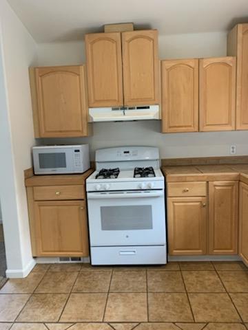 892-894 Calabasas Road Watsonville, CA 95076 - Photo 41 of 53 a kitchen with stainless steel appliances granite countertop a stove a sink and a microwave