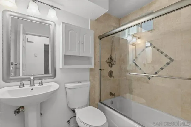 an empty room with a kitchen and sink