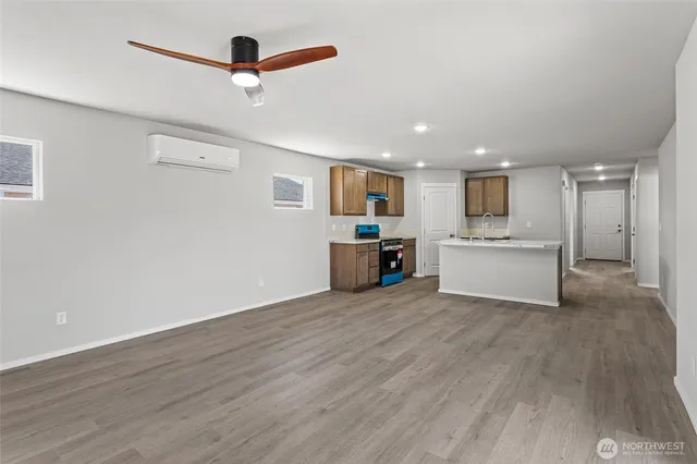 a view of a kitchen with wooden floor and a ceiling fan