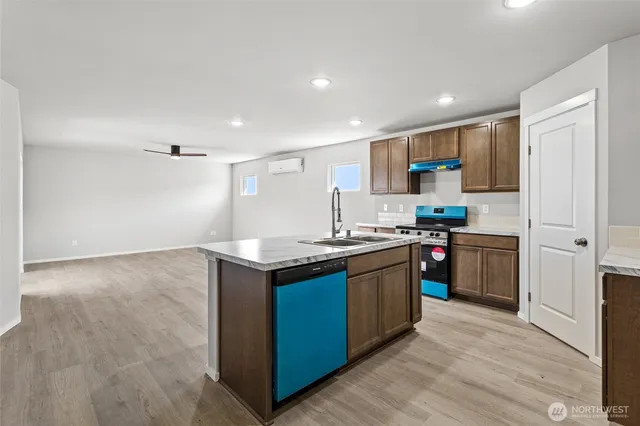 a kitchen with granite countertop a sink and a stove top oven