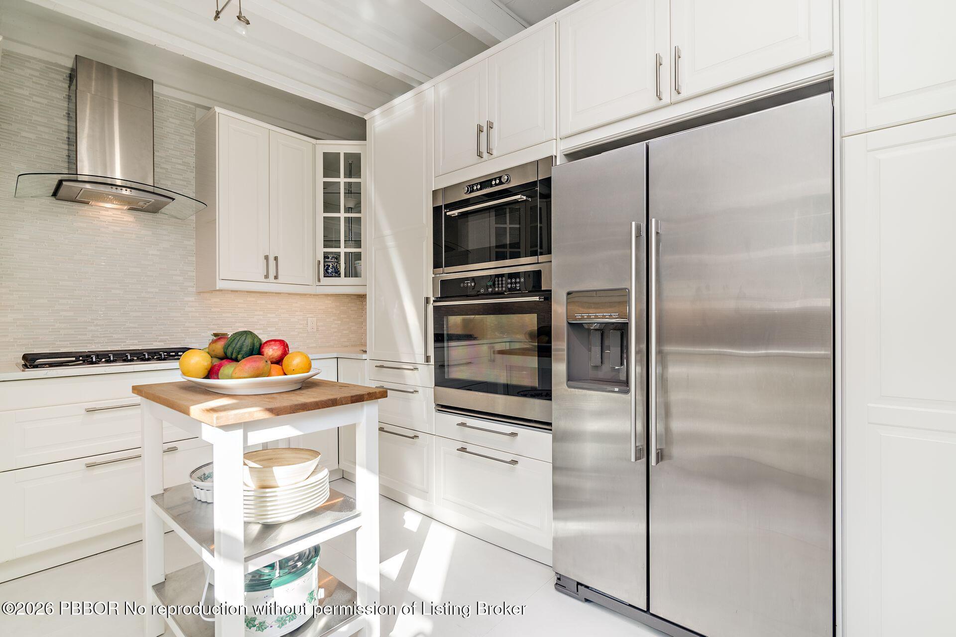 224 Churchill Road West Palm Beach, FL 33405 - Photo 12 of 33 a kitchen with granite countertop stainless steel appliances and a refrigerator