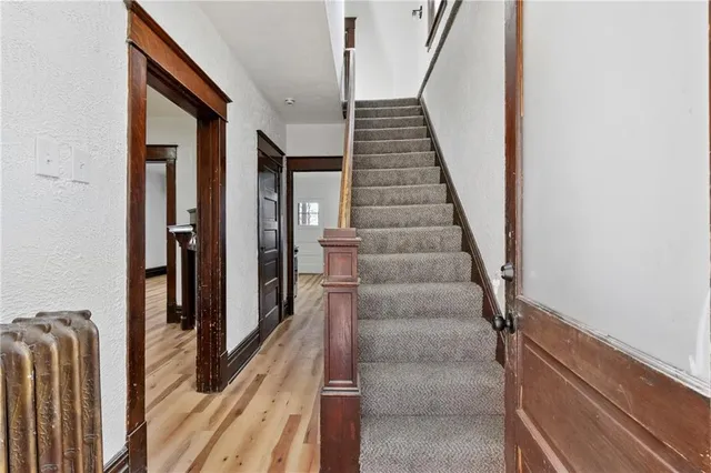 a view of a hallway with wooden floor and entryway
