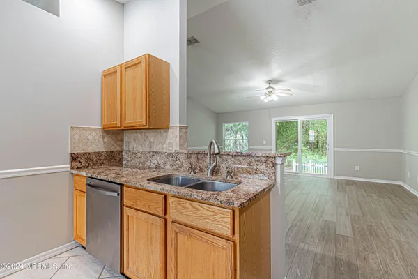 a kitchen with a sink stove and cabinets