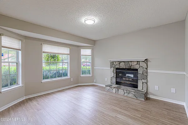 a living room with furniture wooden floor and a fireplace