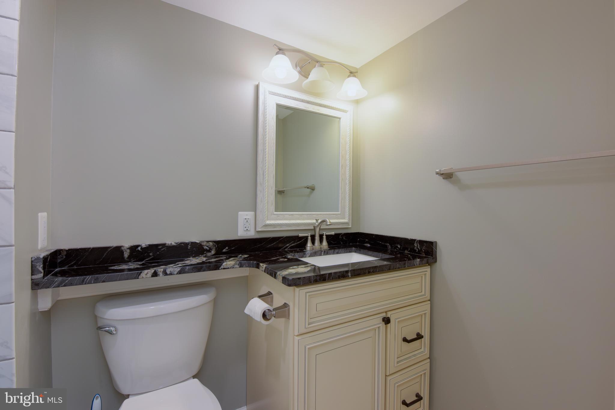 2901 Marsala Court Woodbridge, VA 22192 - Photo 26 of 30 a bathroom with a granite countertop sink and a mirror