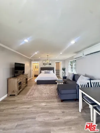 a bedroom with a bed and a television