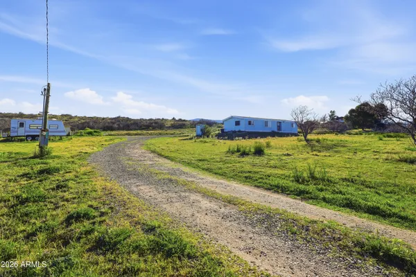 a view of a golf course with an ocean