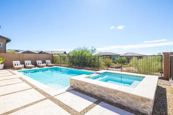 a view of a swimming pool with a lounge chair