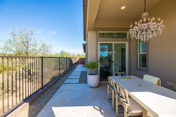 a view of a balcony dining table and chairs