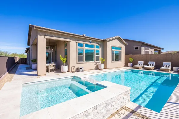 a view of a house with a backyard porch and sitting area