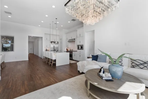 a living room with furniture and a chandelier