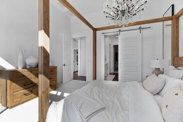 a bedroom with a bed and a flat tv screen on the dresser