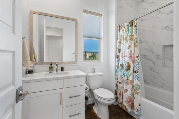 a bathroom with a toilet sink and shower