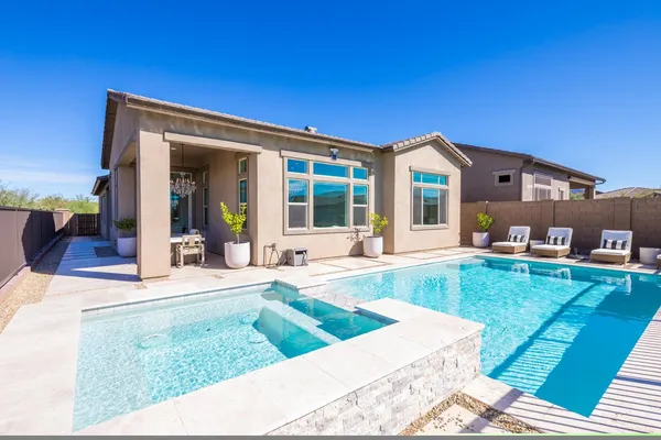 a view of a house with a backyard porch and sitting area