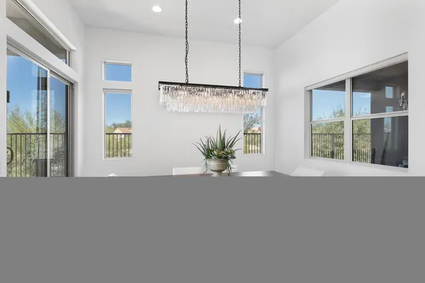 a white kitchen with white cabinets and stainless steel appliances