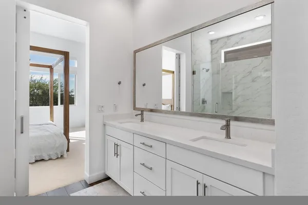 a kitchen with stainless steel appliances granite countertop a sink and a refrigerator