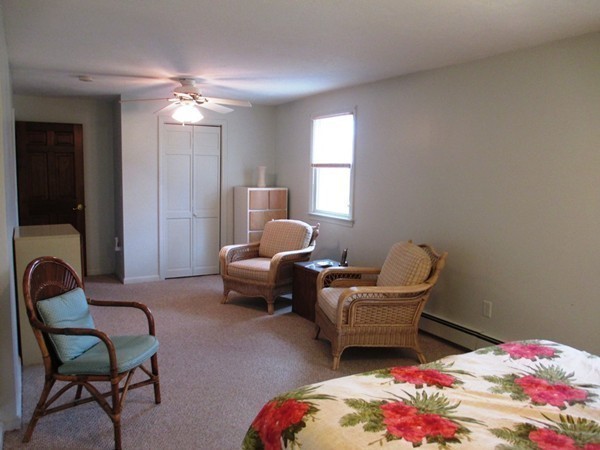 105 George Hill Road Grafton, MA 01519 - Photo 12 of 22 a bedroom with a bed and a chandelier