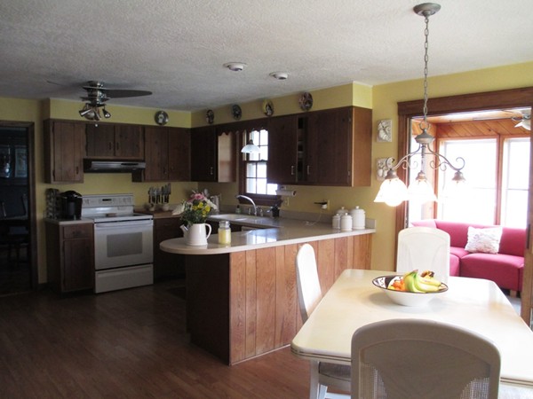 105 George Hill Road Grafton, MA 01519 - Photo 2 of 22 a kitchen with kitchen island granite countertop a sink cabinets and wooden floor