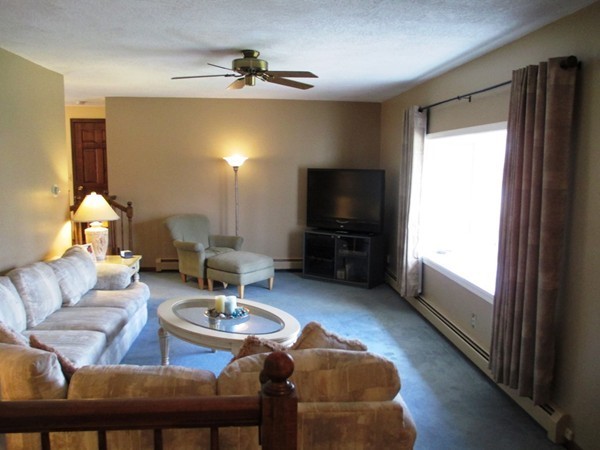 105 George Hill Road Grafton, MA 01519 - Photo 8 of 22 a living room with furniture and a flat screen tv