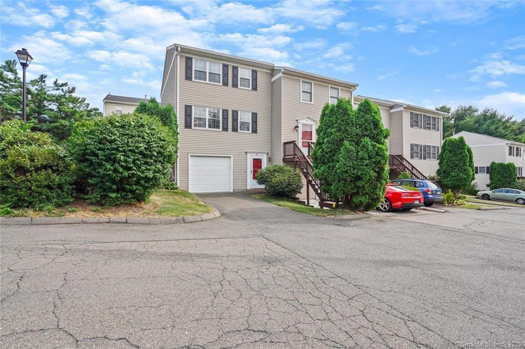a view of a street with a building and trees in the background