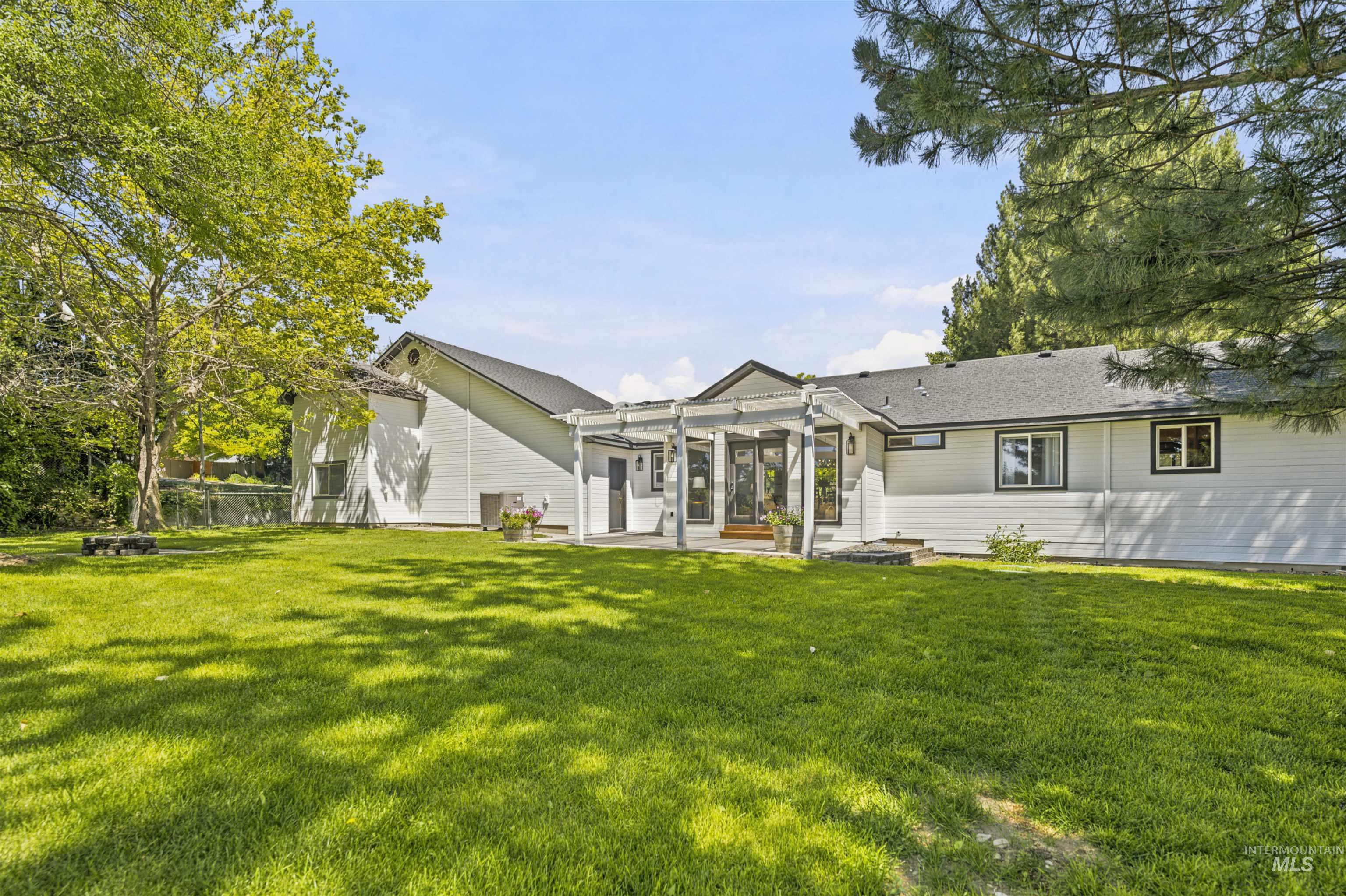 24864 Coventry Drive Caldwell, ID 83607 - Photo 42 of 49 Expansive lawn area with mature trees and a fenced perimeter