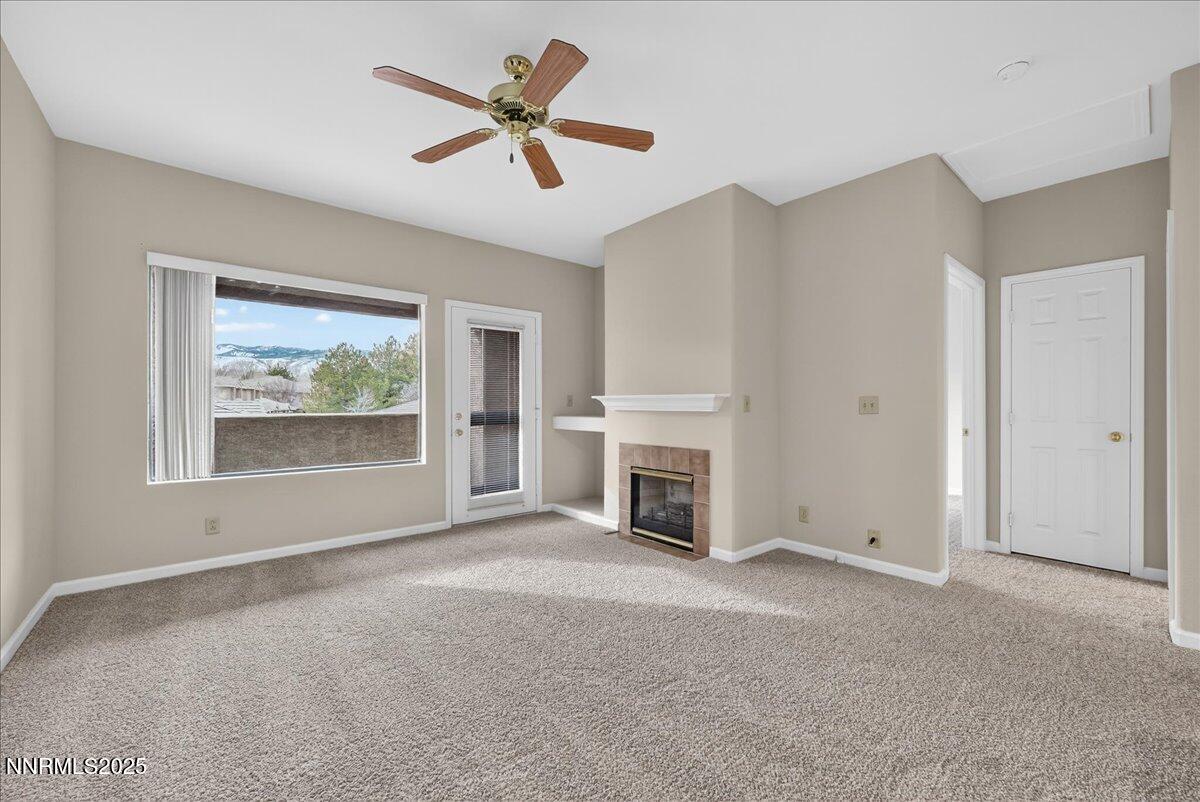 900 South Meadows Parkway, Unit 2322 Reno, NV 89521 - Photo 13 of 40 an empty room with windows fireplace and fan