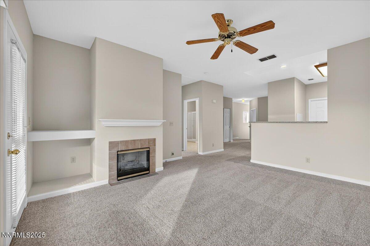 900 South Meadows Parkway, Unit 2322 Reno, NV 89521 - Photo 14 of 40 a view of a livingroom with a fireplace and a ceiling fan