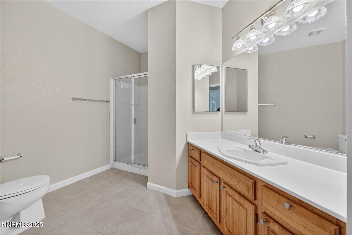 900 South Meadows Parkway, Unit 2322 Reno, NV 89521 - Photo 23 of 40 a spacious bathroom with a double vanity sink a toilet and a mirror