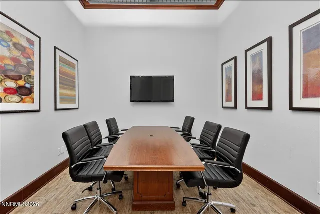 a room with gym equipment and large windows