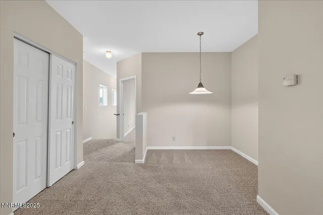 a view of a room with a sink and a mirror