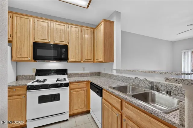 a kitchen with granite countertop white cabinets and white appliances