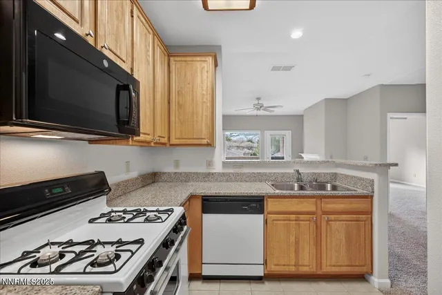 a kitchen with stainless steel appliances a stove a sink and a microwave