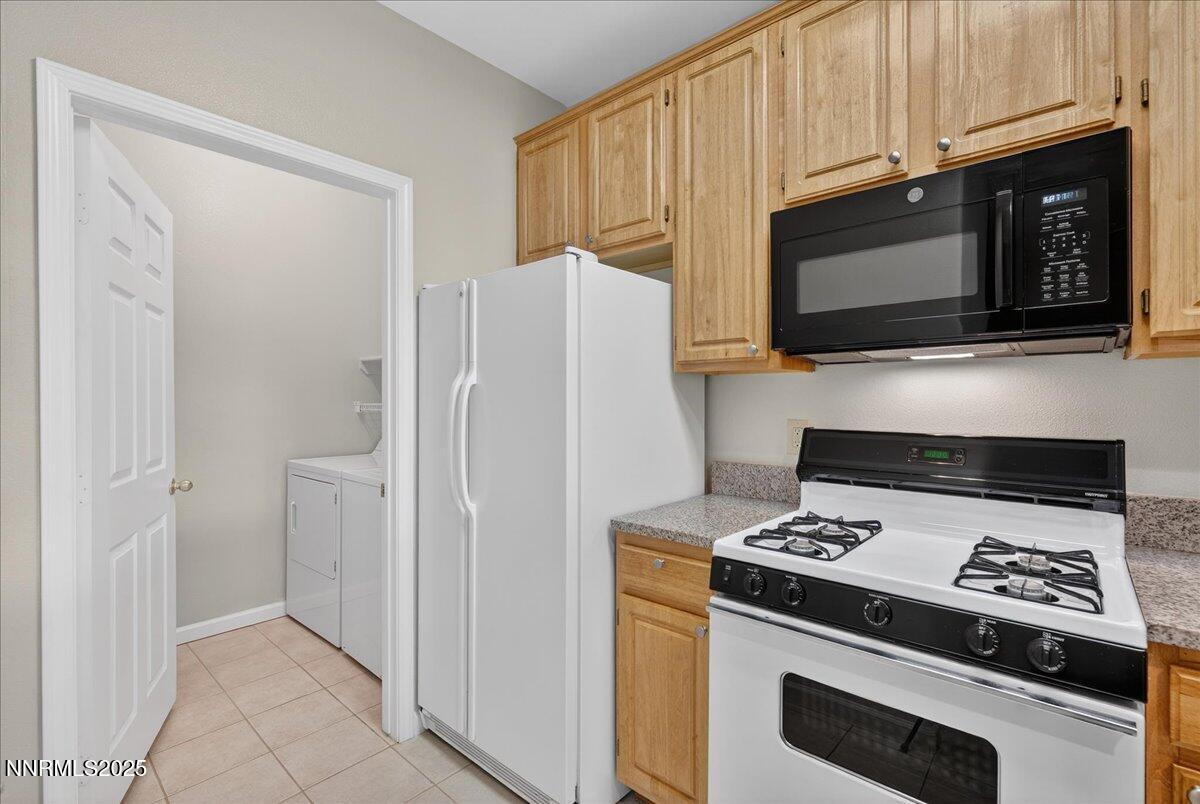 900 South Meadows Parkway, Unit 2322 Reno, NV 89521 - Photo 10 of 40 a kitchen with stainless steel appliances a stove a microwave and a refrigerator