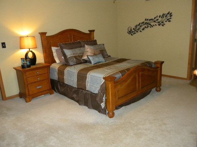 10745 Chicory Ridge Way Roscoe, IL 61073 - Photo 14 of 25 a bedroom with a bed and a lamp on dresser