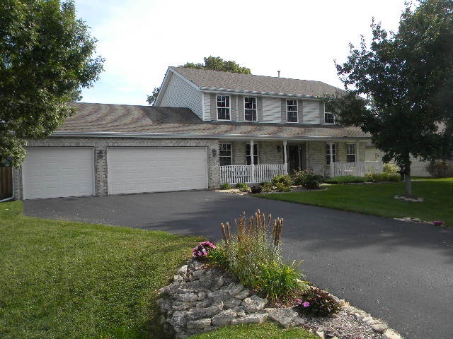 10745 Chicory Ridge Way Roscoe, IL 61073 - Photo 2 of 25 a front view of a house with a yard and garage
