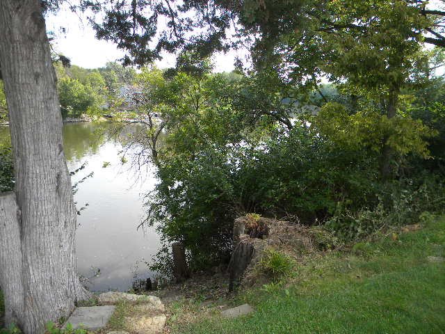 10745 Chicory Ridge Way Roscoe, IL 61073 - Photo 22 of 25 a view of a lake in between two trees