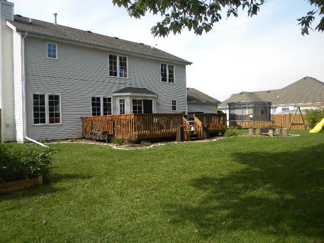 10745 Chicory Ridge Way Roscoe, IL 61073 - Photo 24 of 25 a front view of house with yard and green space