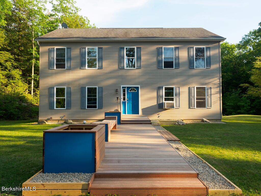 664 Main Road Monterey, MA 01245 - Photo 1 of 19 a front view of house with yard outdoor seating and garden