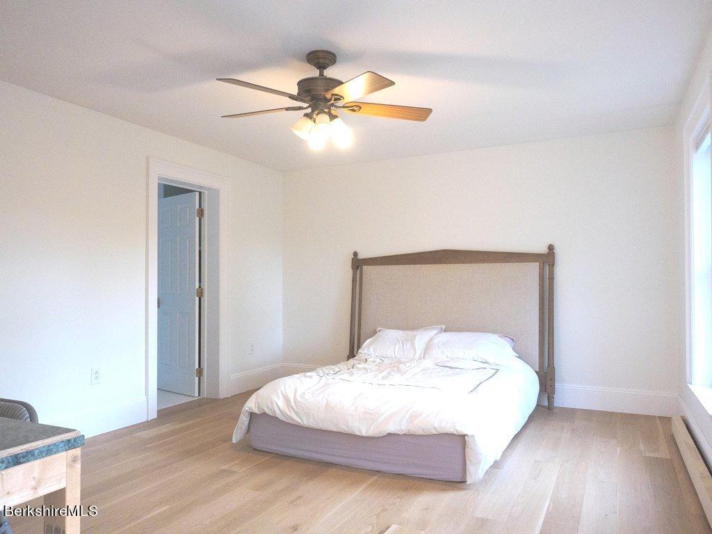 664 Main Road Monterey, MA 01245 - Photo 11 of 19 a bedroom with a bed and a painting