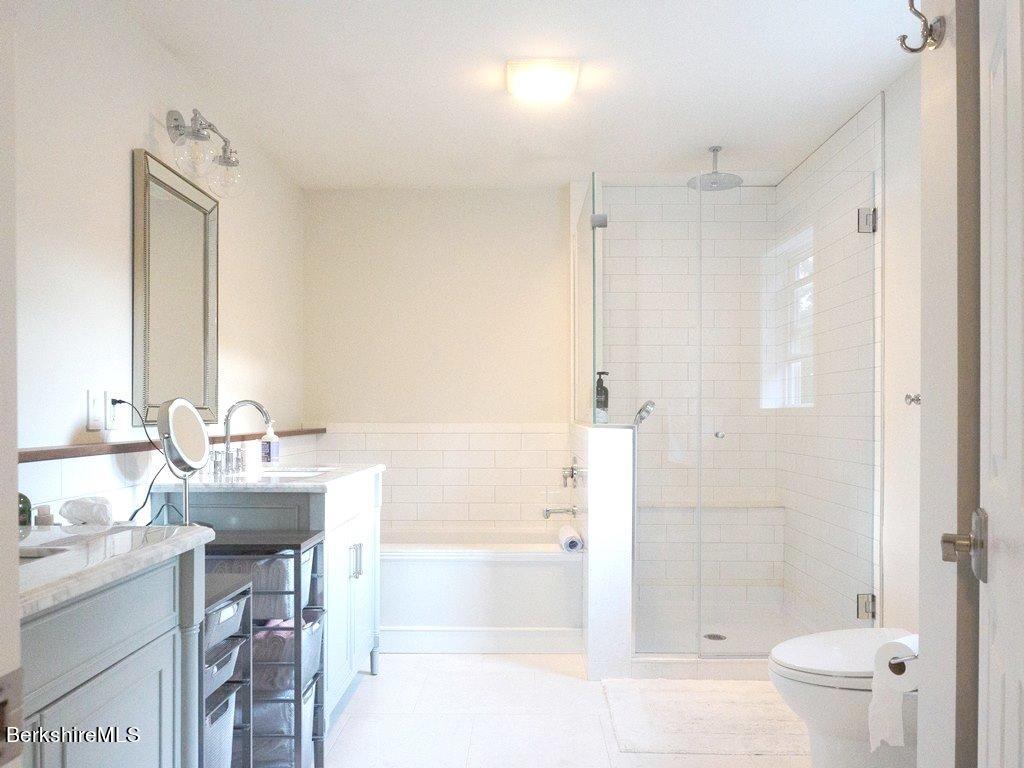 664 Main Road Monterey, MA 01245 - Photo 12 of 19 a bathroom with a bathtub shower sink vanity and toilet