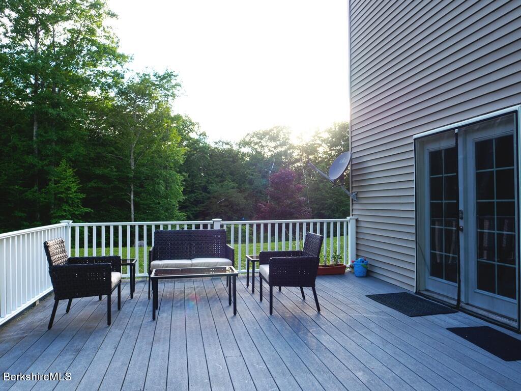 664 Main Road Monterey, MA 01245 - Photo 17 of 19 a view of a deck with a table and chairs with wooden floor