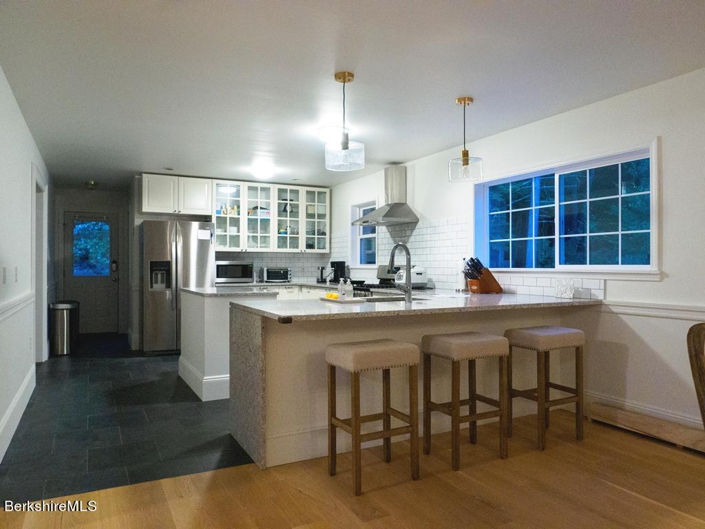 664 Main Road Monterey, MA 01245 - Photo 4 of 19 a kitchen with stainless steel appliances a sink stove and refrigerator