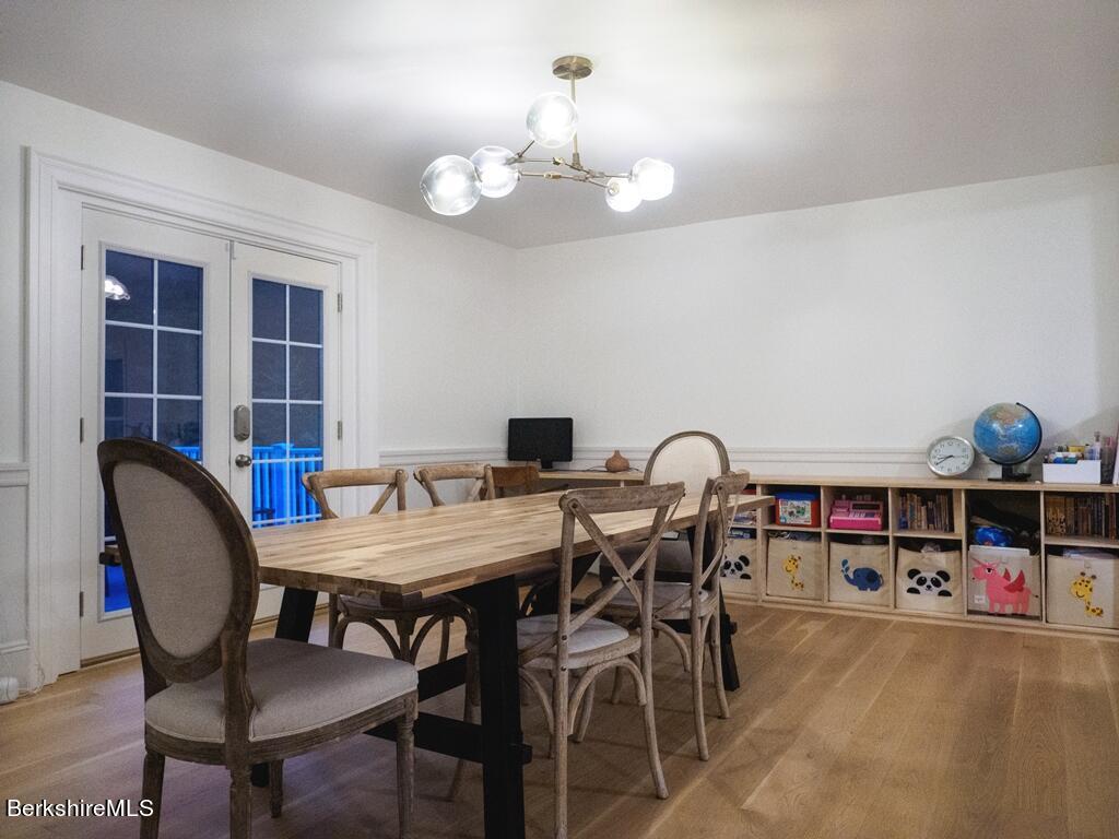 664 Main Road Monterey, MA 01245 - Photo 6 of 19 a view of a dining room with furniture and a chandelier