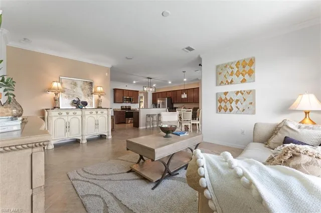 a living room with furniture and kitchen view