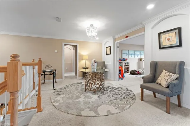 a living room with furniture and a chandelier